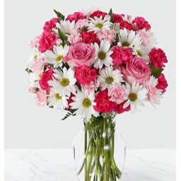 Florero con flores en tonos rosado y blanco